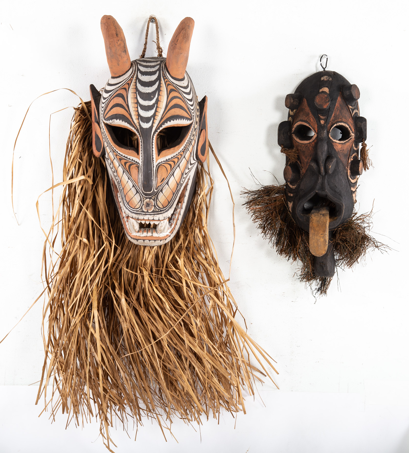 TWO DECORATIVE MASKS Both painted