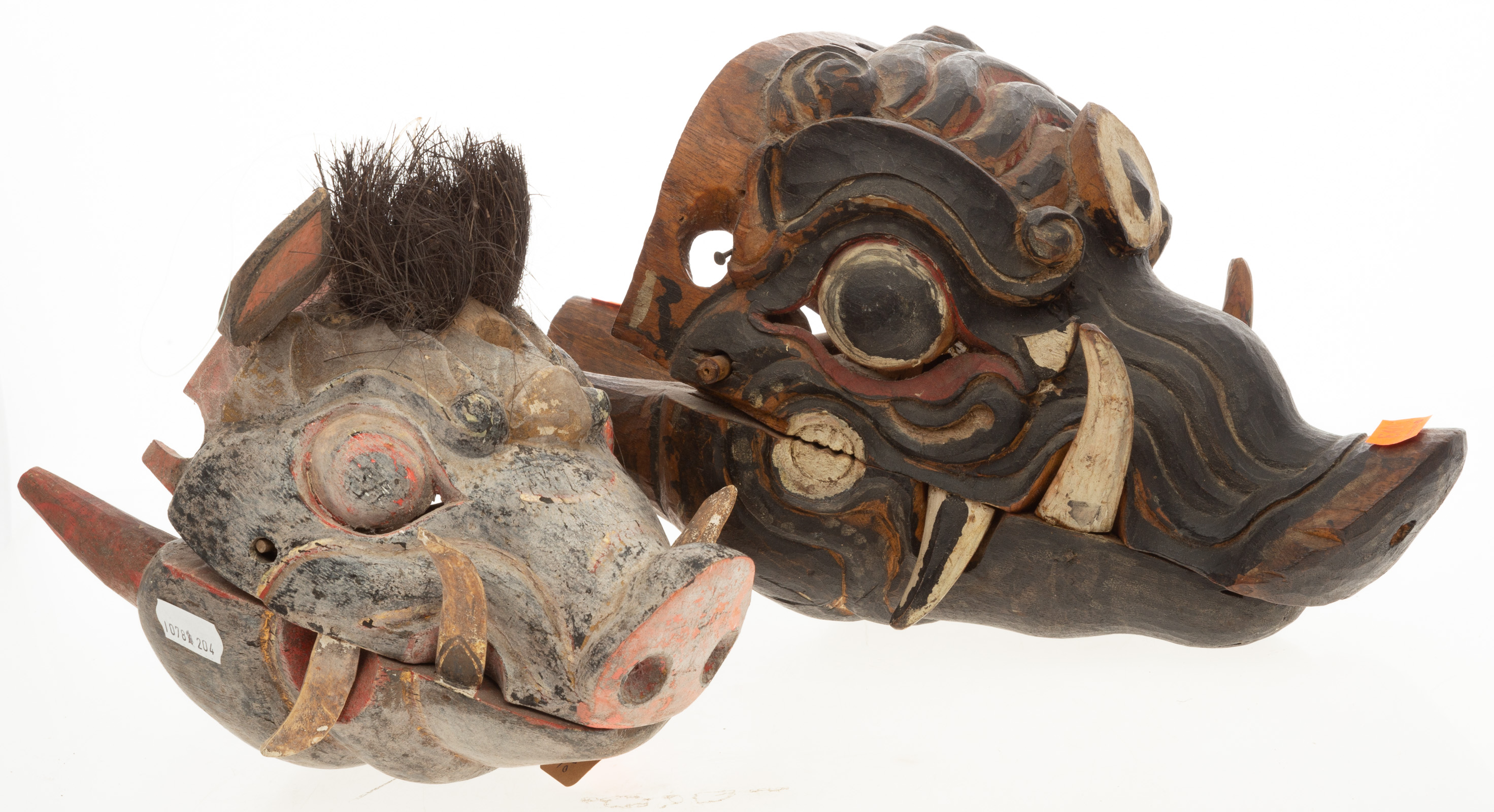 TWO ASIAN STYLE CARVED WOODEN MASKS