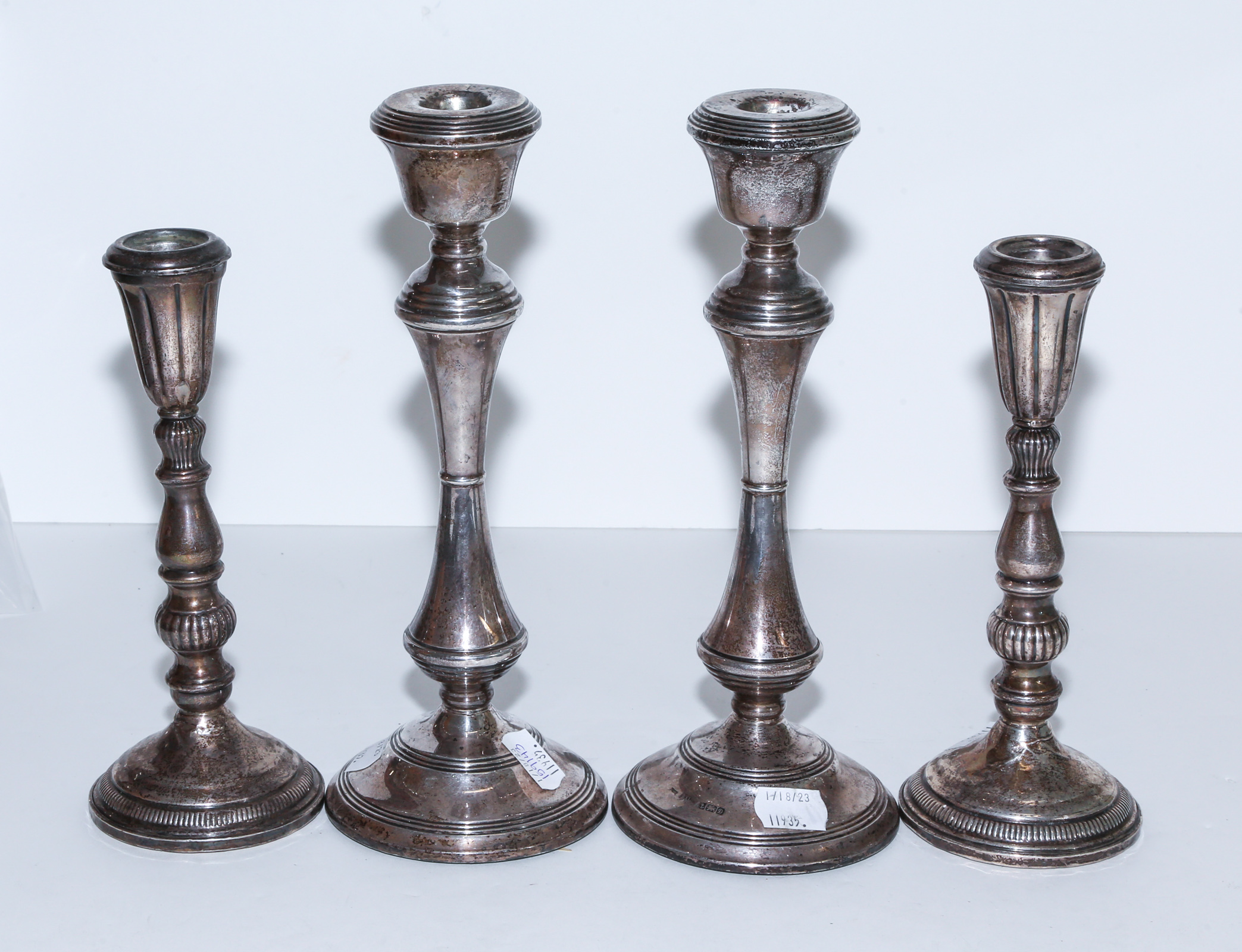 FOUR STERLING WEIGHTED CANDLESTICKS