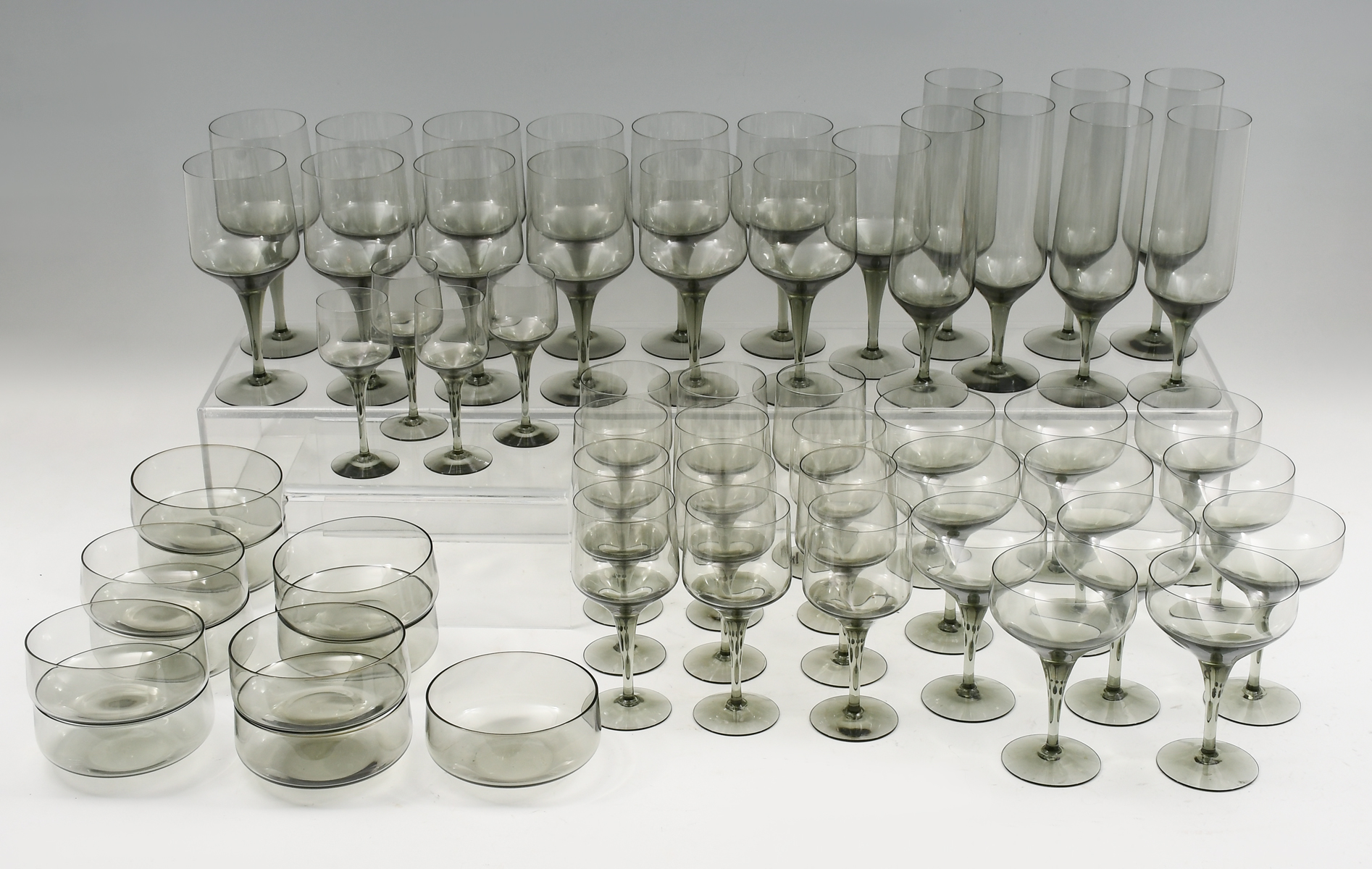 57 PC. ORREFORS SMOKED CRYSTAL STEMWARE: