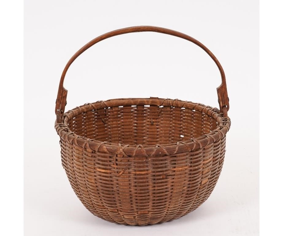 Early woven basket with swing handle,