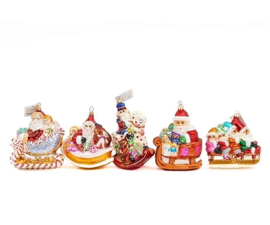 Five large Santas on sleighs, all different.
Approx