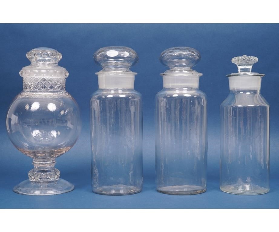 Two similar clear glass apothecary