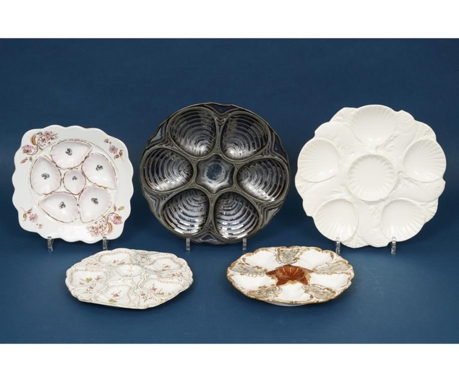 Five oyster plates including a