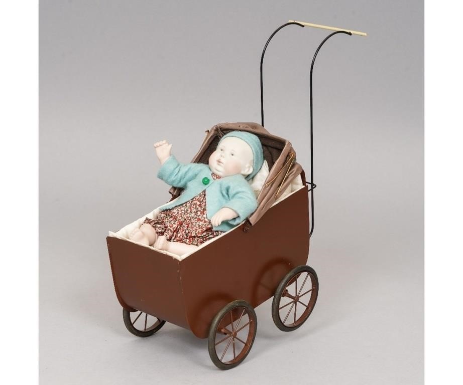 Baby Doe in a brown pram, with tufted