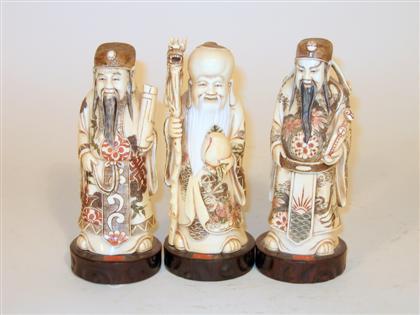Three mammoth ivory and stained figures