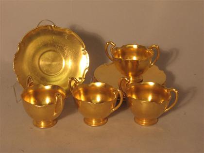 Twelve Limoges porcelain gilt bouillon