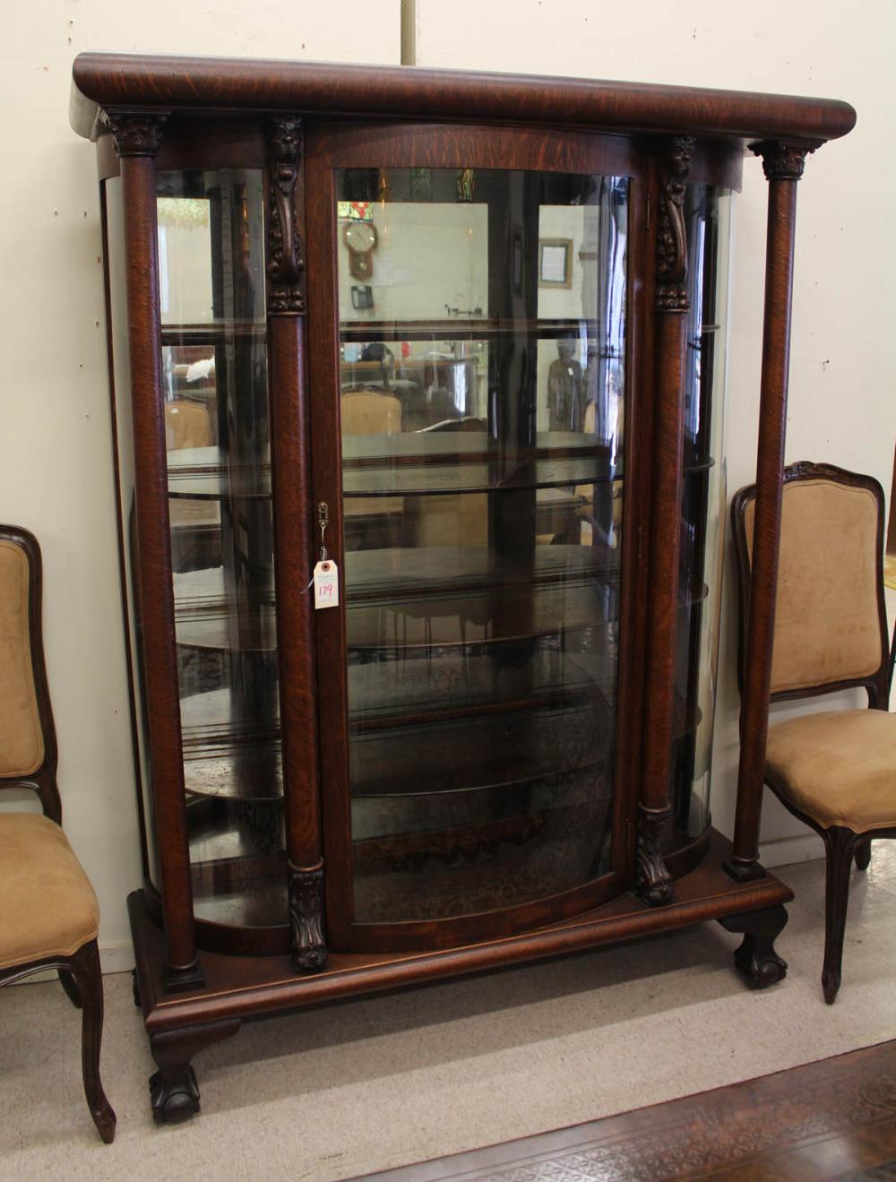 AN OAK AND CURVED GLASS CHINA CABINETAN