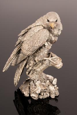 A filled silver model of a bird