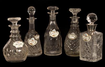 Five cut glass decanters and enamelled