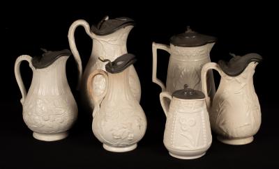 Six saltware jugs, floral decoration,