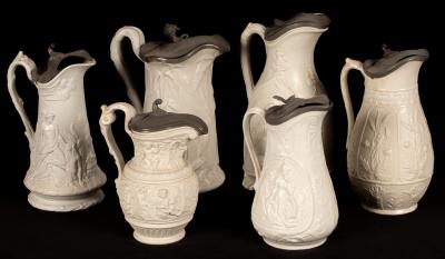 Six saltware jugs, various patterns,