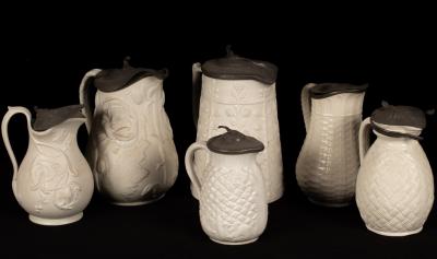 Six saltware jugs, various patterns,
