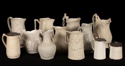 Twelve saltware jugs, various patterns,