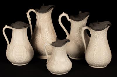 Five saltware jugs, floral decoration,