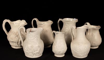 Fifteen saltware jugs, various