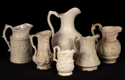Six saltware jugs, decorated figures