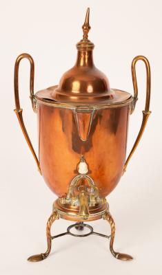 A twin handled copper and brass urn