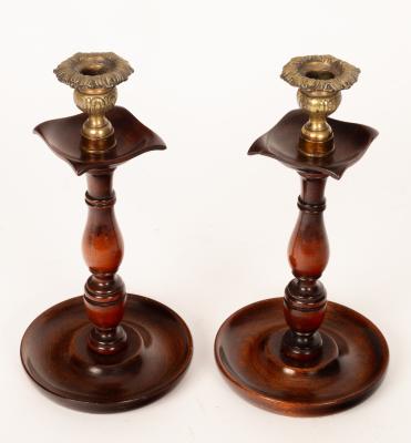 A pair of turned wood candlesticks,