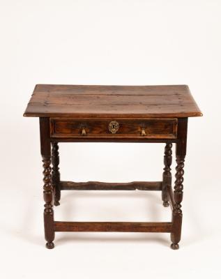 A late 17th Century elm table fitted