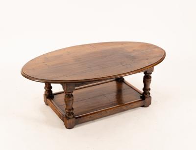 An oval oak table with platform beneath,