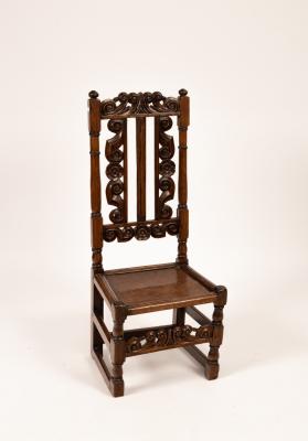 An oak single chair with twin carved