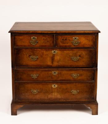 A walnut chest of three long and two