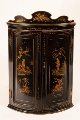 A black and gold lacquered bowfronted