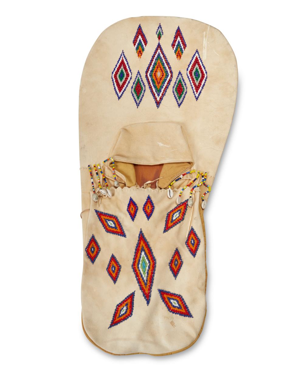 A NATIVE AMERICAN BEADED HIDE CRADLEBOARDA