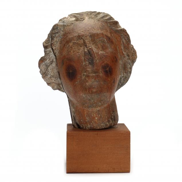 CARVED PINE FEMALE HEAD FROM A