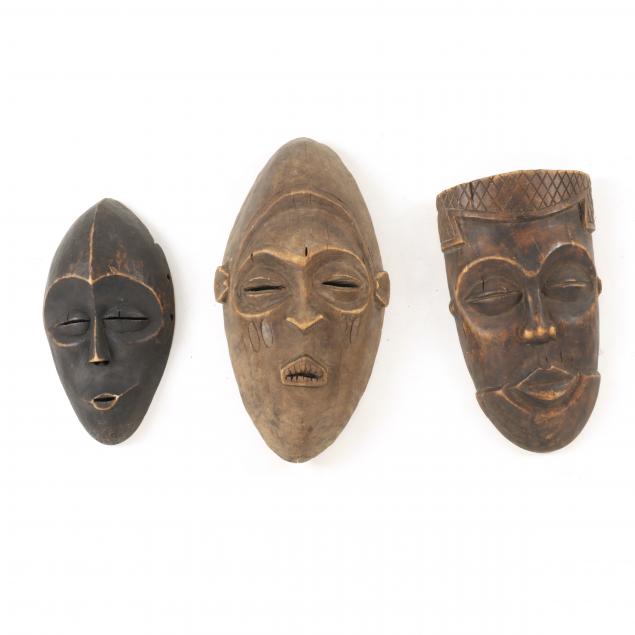 THREE (3) CARVED WOOD AFRICAN MASKS