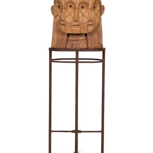 A Carved Wood Sculpture of a Three-Faced