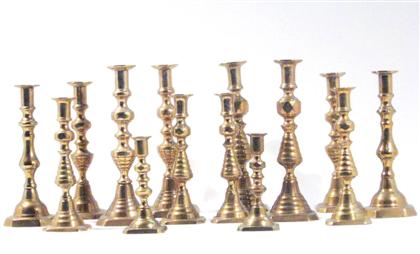 Group of brass push-up candlesticks