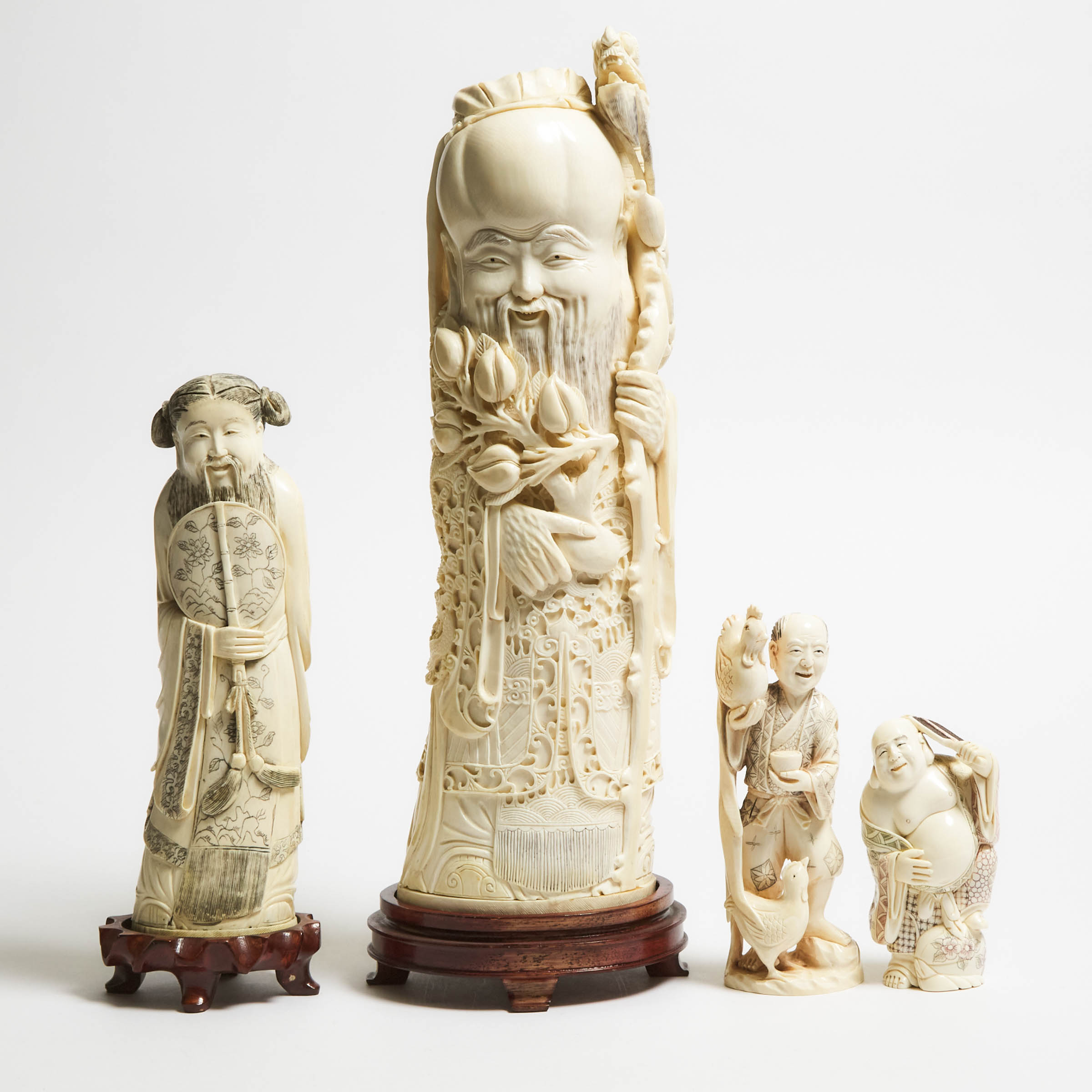 A Group of Four Ivory Figures,
