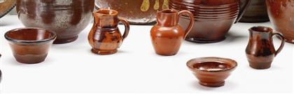 Nine redware miniature bowls and pitchers