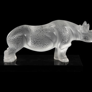 A Lalique Rhinoceros on a black 2f6f44