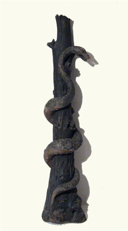 Large carved and painted snake and tree