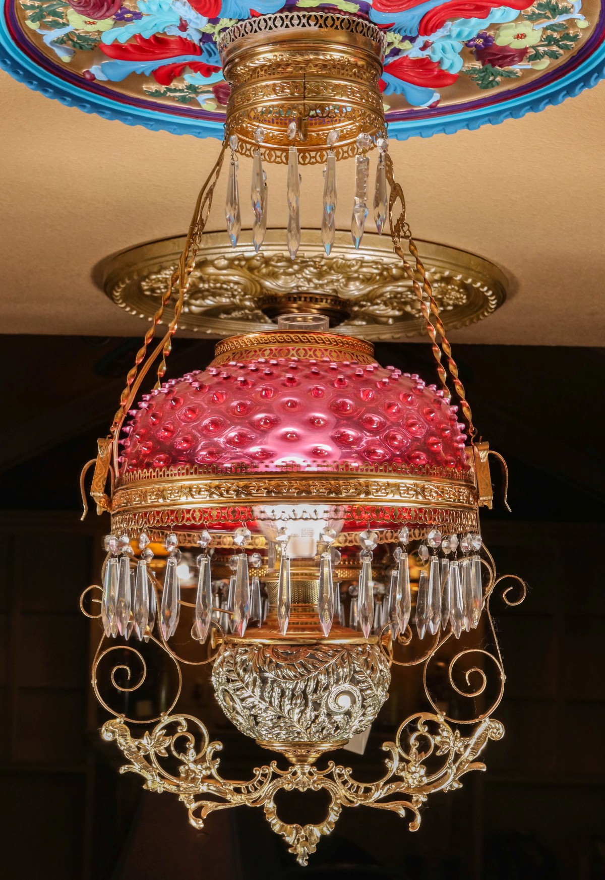 A HANGING LIBRARY LAMP WITH ORNATE