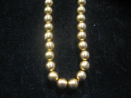 Gold bead necklace    Strung on