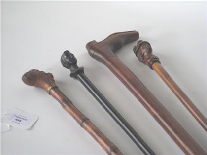 Four walking sticks with carved