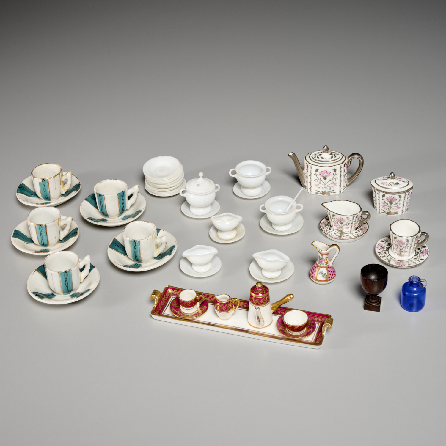 MINIATURE PORCELAIN AND GLASS TEA SETS,