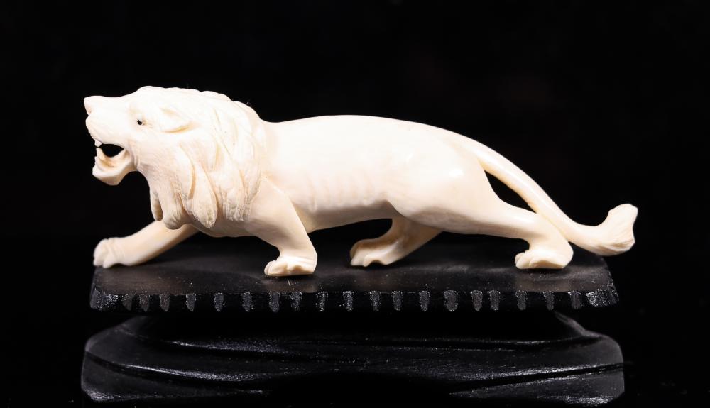 CARVED BONE LION ON STANDCarved