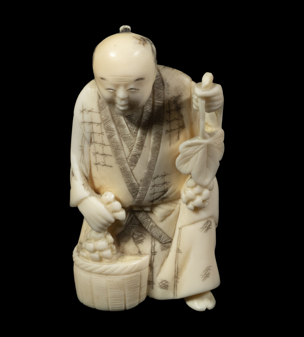 JAPANESE OKIMONO FIGURE A Seated Traveler