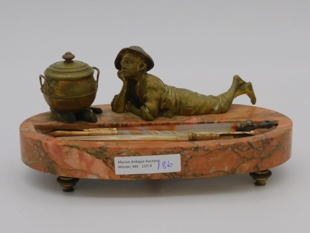 A BRONZE FOOTED AND MARBLE FIGURAL INKWELL.