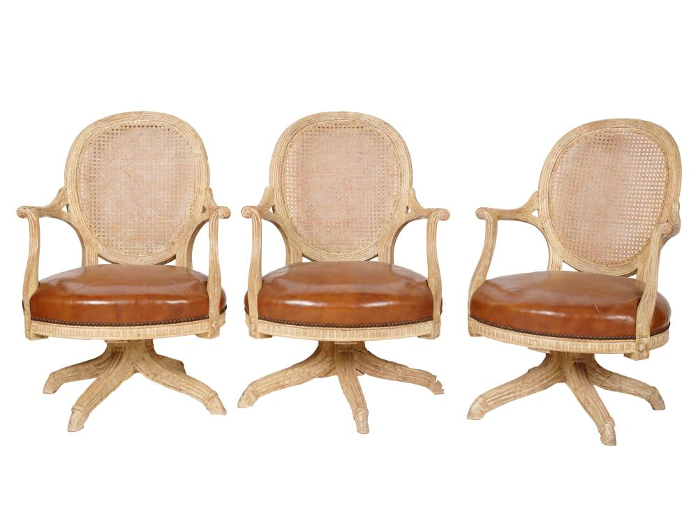 THREE BLEACHED WOOD SWIVEL ARMCHAIRSmanufacturer