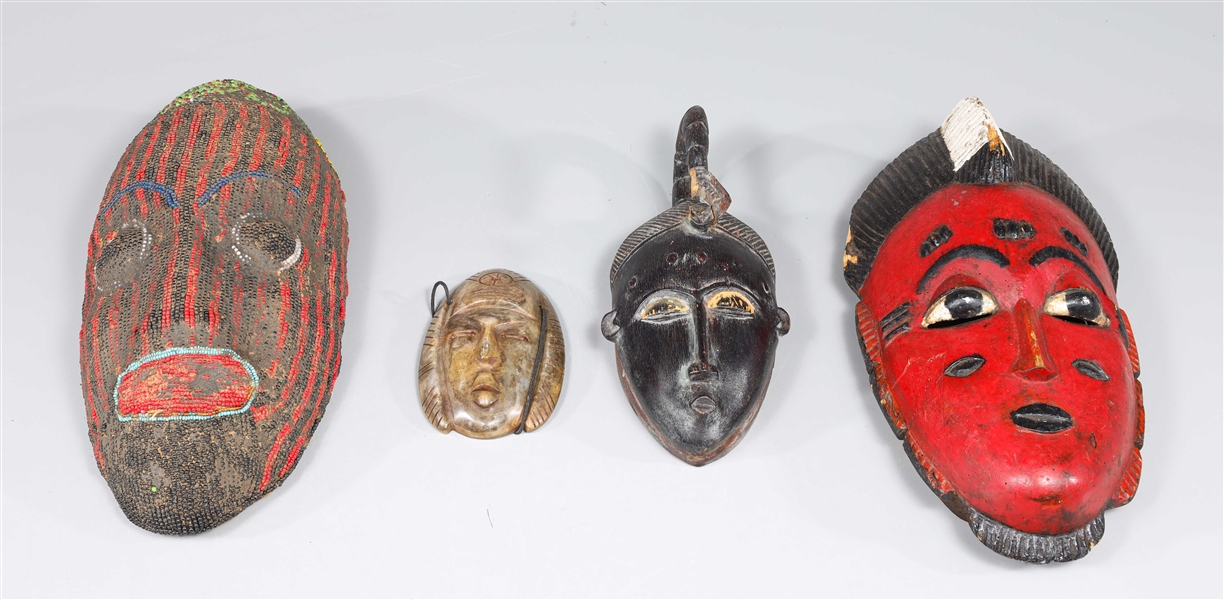 Group of four carved tribal masks  304b25