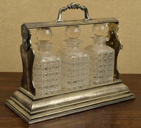 An antique three bottle silver