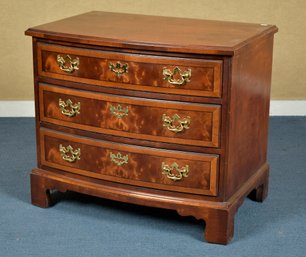 A vintage three drawer inlaid mahogany