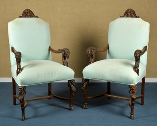 A pair of antique walnut arm chairs