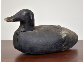 An antique wood duck decoy, in black